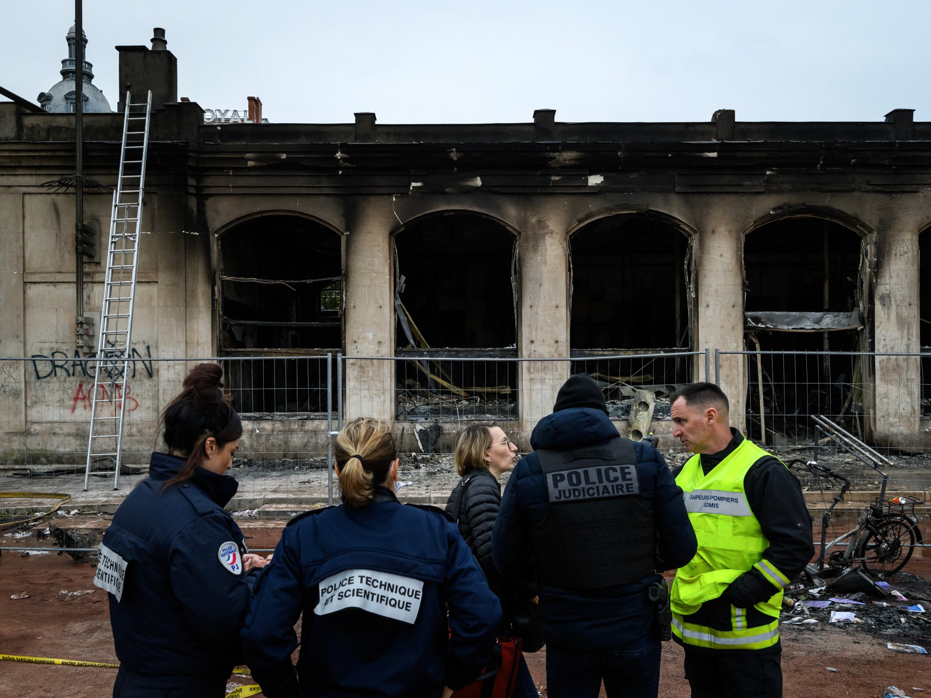 France imposes partial curfews after weekend riots; Macron keeps his interior minister